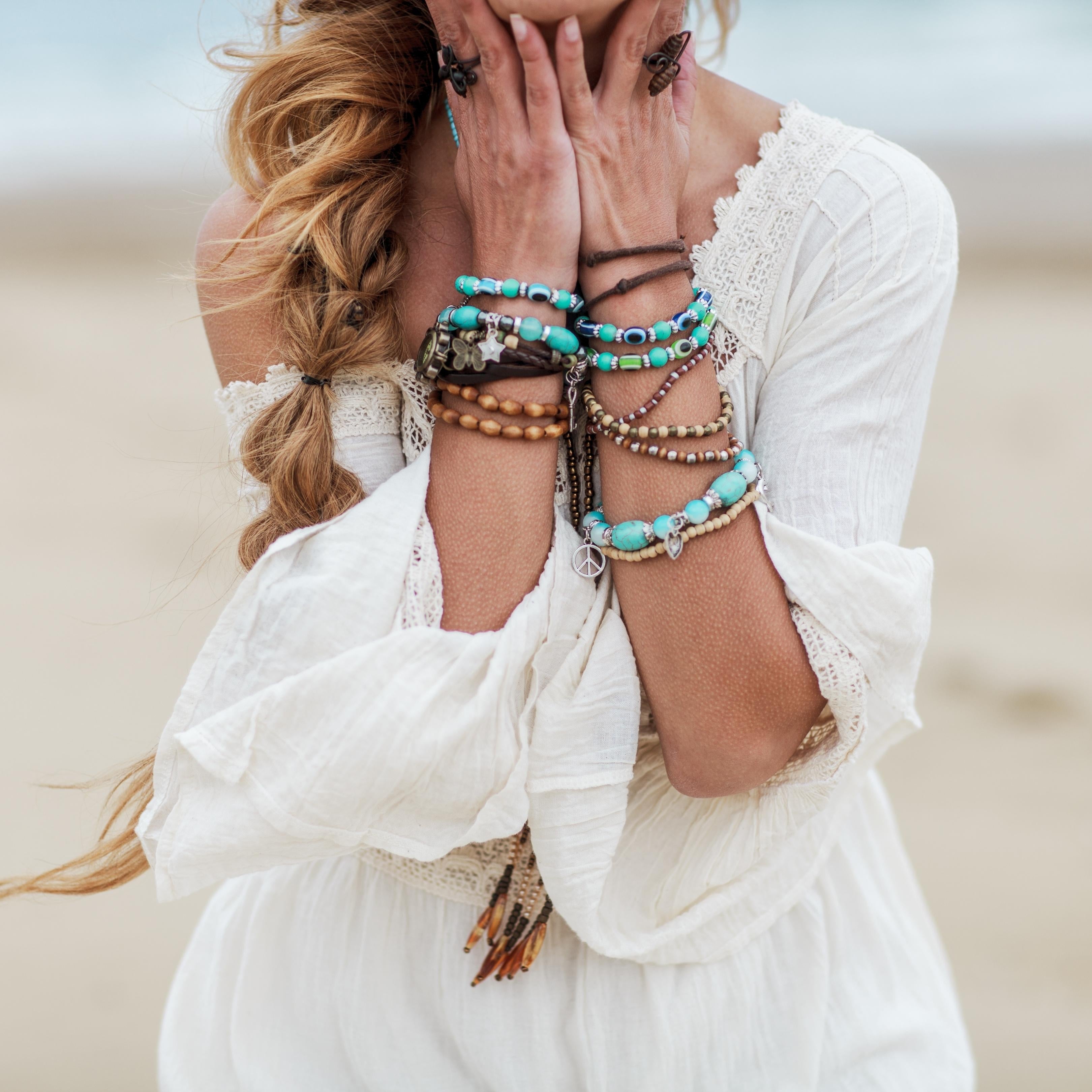 close up of ladies lower arms covered in bracelets